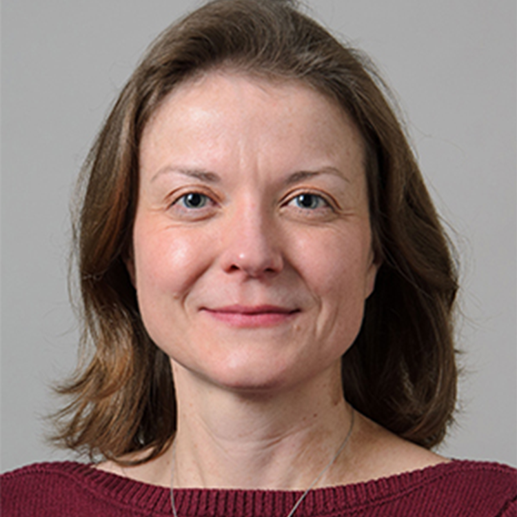 A headshot of Natalie Shook against a gray background.